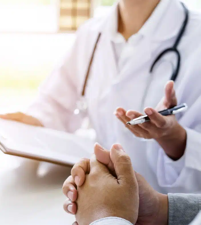 Sports medicine doctor discussing with a patient.